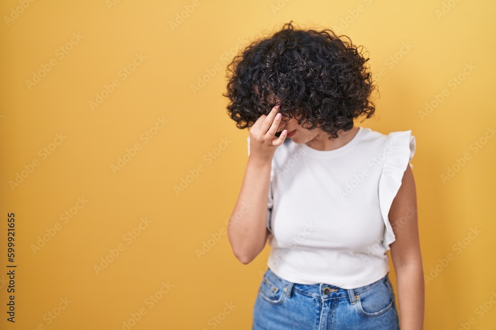 Poster young middle east woman standing over yellow background tired rubbing nose and eyes feeling fatigue 