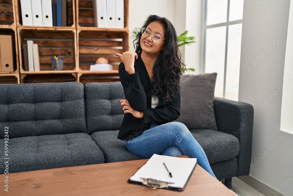 Sticker young asian woman at consultation office smiling with happy face looking and pointing to the side wi