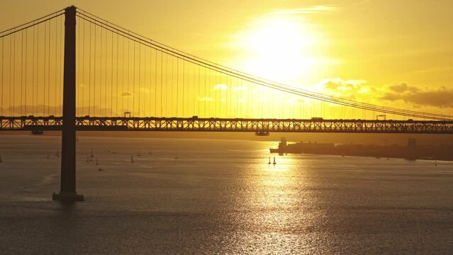 Suspension bridge at bright orange sunset