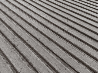 Abstract view from a drone showing the recently ploughed arable field, set into parallel lines.
