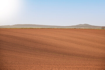 A plowed field for spring planting of agricultural crops. Horizontal view. Photo. copy space