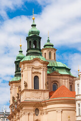 Fototapeta na wymiar Baroque art and architecture in Prague. Church of Saint Nicholas beautiful dome and twin bell towers erected in 18th centuty in Stare Mesto (Old Town) district