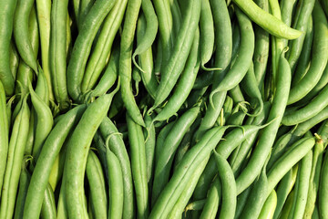 Stack of green beans on a market stall