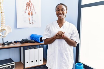 African american woman pysiotherapist smiling confident standing at rehab clinic