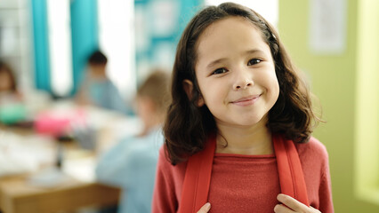 Adorable hispanic girl student smiling confident standing at classroom