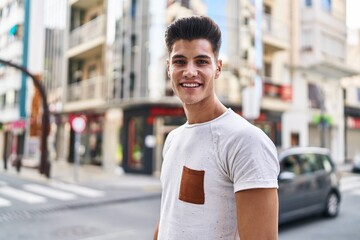 Fototapeta premium Young hispanic man smiling confident standing at street
