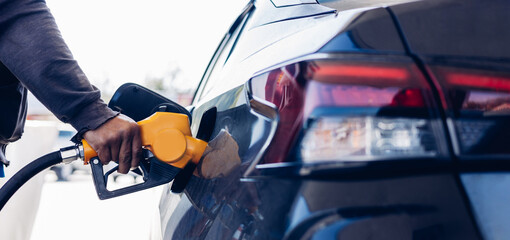 Man Refill and filling Oil Gas Fuel at station. Gas station - refueling.