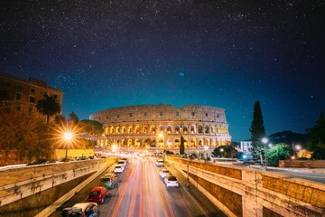 Washable Wallpaper Murals Colosseum Rome, Italy. Colosseum Also Known As Flavian Amphitheatre In Evening Or Night Time. Night Traffic Light Trails Near Famous World Landmark. Bright Blue Night Sky. Amazing Night Starry Sky Background.