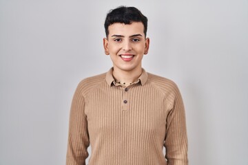 Non binary person standing over isolated background with a happy and cool smile on face. lucky...