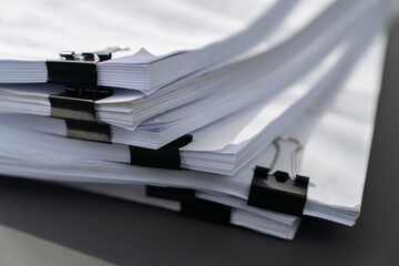 Closeup office table with organized stacked papers, as the concept of organized document management...