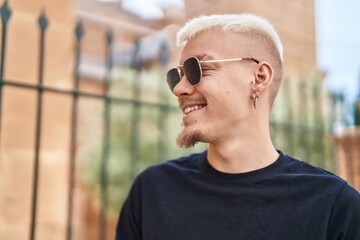 Young caucasian man smiling confident looking to the side at street