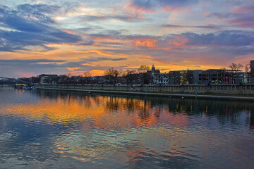 Fototapeta premium a bright colourful sunset over the Vistula River in Krakow, Poland. A city evening landscape