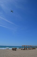 Obraz premium beach and sea with a aircraft at sky