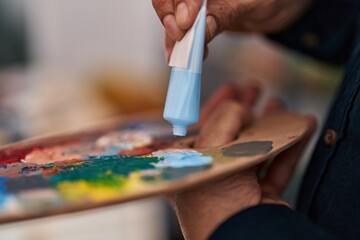 Fototapeta na wymiar Senior man mixing color on palette at art studio