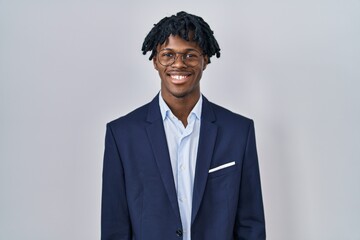Young african man with dreadlocks wearing business jacket over white background with a happy and...