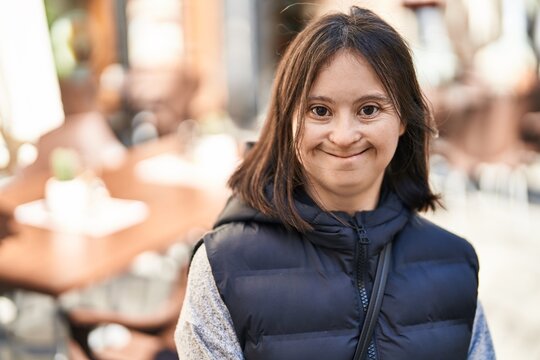 Young woman with down syndrome smiling confident standing at street