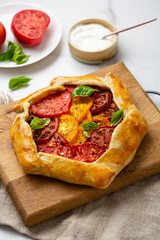 Summer tart galette with heirloom tomatoes healthy food on cutting board