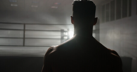 Back view. Copy space. A motivated muay thai sportsman walking towards sparring ring, ready for a fight - martial arts, way to success concept  - obrazy, fototapety, plakaty