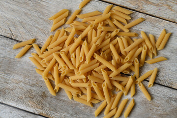 Uncooked Italian pasta. Heap of raw pasta.