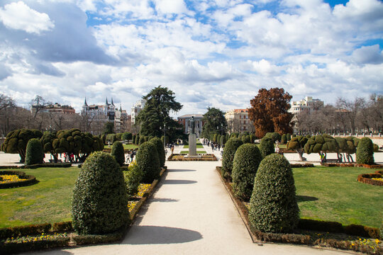 View at Jacinto Benavente statue and Calle de Alfonso XII street at sunny winter day in El Retiro park