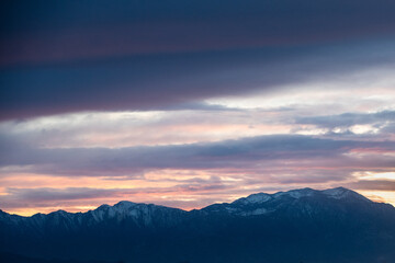 Fototapeta na wymiar Sunset over the snow covered mountains
