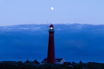 Foto op Canvas the red lighthouse of Schiermonnikoog during the blue hour in the evening in the province of Friesland, the Netherlands © Daniel Doorakkers