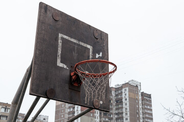 Streetball ring in a poor area of the city. Old basketball hoop. Basketball hoop in the ghetto