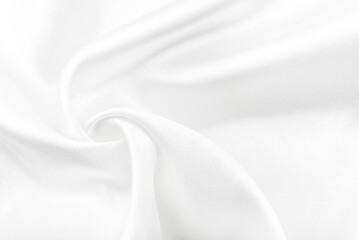 Obraz premium A twisted piece of white fabric. White material or texture with waves and folds. Wrinkled white fabric
