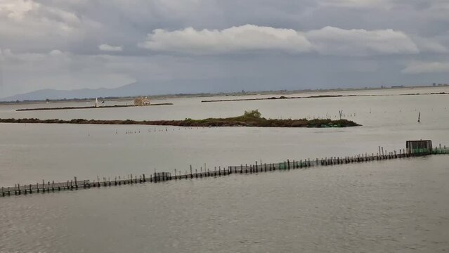 Tranquil view at fishing village Tourlida in Mesolongi sea lagoon in Greece o
n a cloudy day
