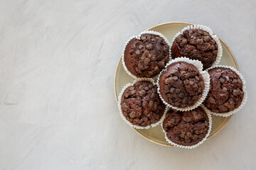 Homemade Dark Chocolate Muffins on a Plate, top view. Overhead, from above, flat lay. Copy space.