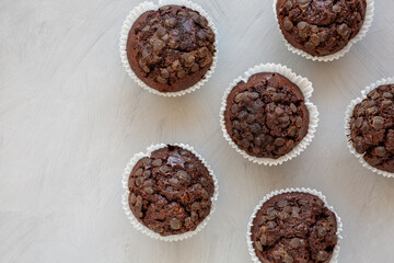 Homemade Dark Chocolate Muffins on a gray background, top view. Overhead, from above, flat lay. Space for text.
