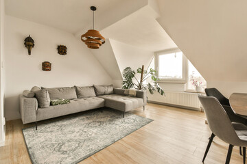 a living room with a couch, chair and rug on the floor in front of the sofa is an area that has...