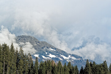 Forested mountains in dense clouds in a winter. Ziller Valle in, Austria - 599970001