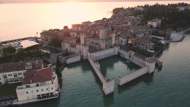 Aerial view during sunset of the medieval town of Sirmione and its beautiful castle near Lake Garda in Italy