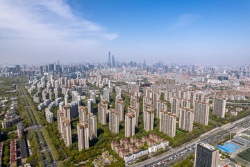 The drone aerial view of residential district in Pudong with skyscrapers in the background, Shanghai, China.