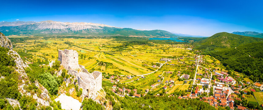Town of Vrlika and Prozor hill fortress ruins aerial panoramic view