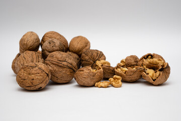 Pile of ripe walnuts on white background