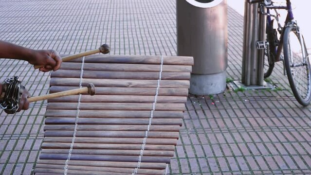 Street performer hands of musician playing the vibraphone xylophone in Cologne, Germany, slow motion