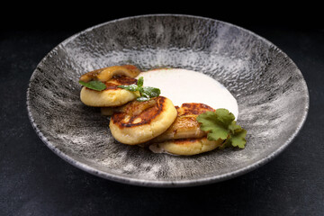 Delicious banana pancakes with sour cream and mint leaves