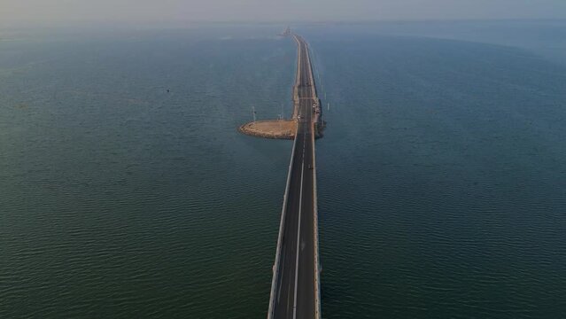 Aerial footage of a long bridge in mid of sea