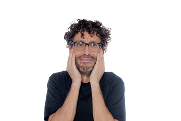 Middle-aged man holding his face with both hands, with gesture of despair, on white background.