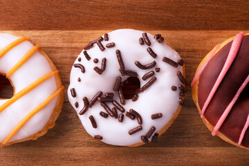 Close-up on a mini donut set directly above. Wooden plank in background. - 599983883