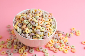 Multicolored corn rings for breakfast on a colored background