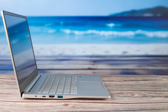 Working from the beach with a laptop with a blurred background