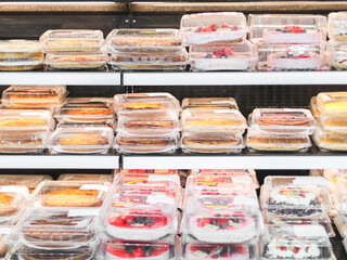 Varieties of cakes and pies on the counter in the store.