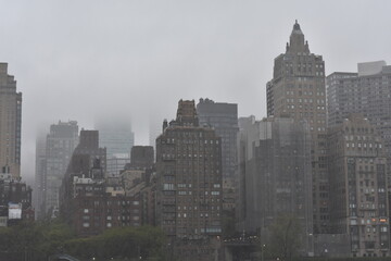 Fototapeta na wymiar Low Clouds on Rainy Day View of Manhattan from Roosevelt Island 