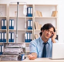 Young male employee in blood transfusion concept