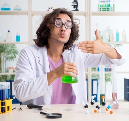 Funny male chemist working in the lab