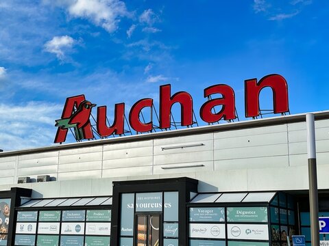 Lille, France - April 12 2023: the big auchan sign has been placed on top off a location of the grocery store chain property