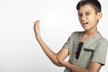 indian boy with painful grimace expression holding his elbow joint injury area in white background